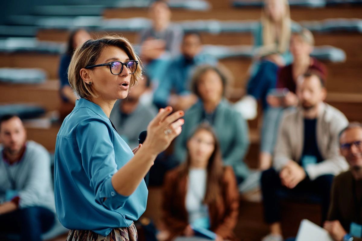A woman speaking to a room of people